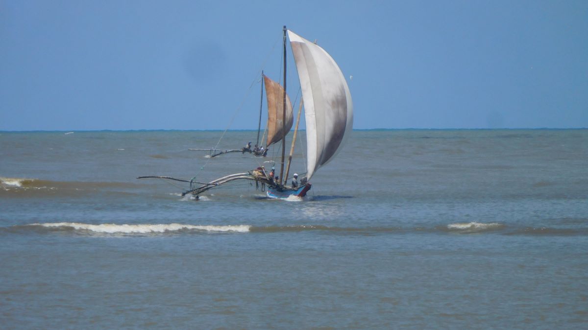 A local fishing boat under sail.